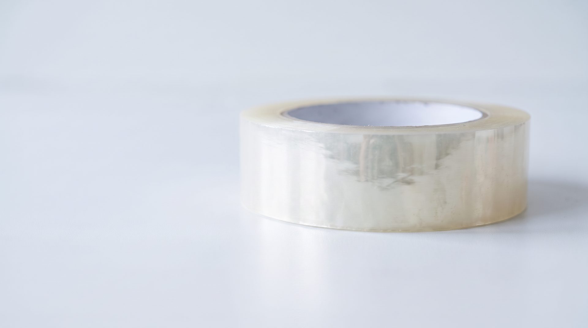 A clear tape roll; its end is invisible